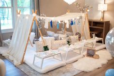 a room with white furniture and decorations on the floor