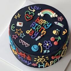 a birthday cake is decorated with colorful icing