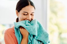 a woman with her eyes closed wrapped in a towel