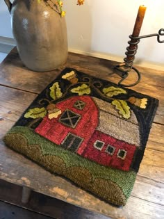 a table with a vase and rug on it