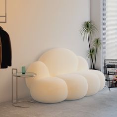 a white couch sitting next to a table in a room