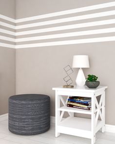 a white table sitting next to a gray and white wall