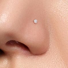 a woman's nose with a tiny diamond on it