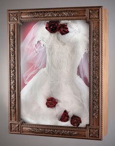 a wedding dress in a frame with flowers