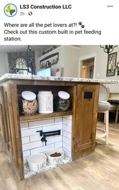 a kitchen island made out of an old cabinet and some buckets on the counter