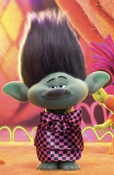 an animated troll with black hair and checkered dress standing in front of another character