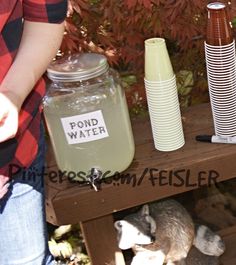 there are many items on the table that include cups, jars and radishes