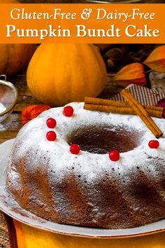 a bundt cake on a plate with cinnamon sticks and pumpkins in the background