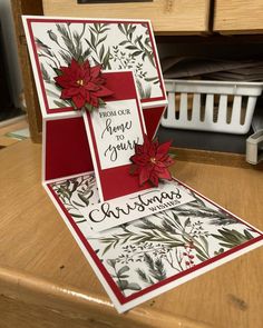 a christmas card with poinsettis on it