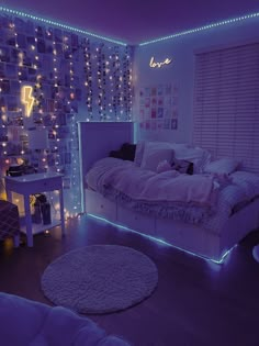 a bedroom decorated in purple and white with lights on the walls