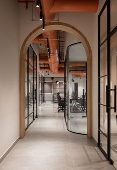 an office hallway with glass walls and chairs