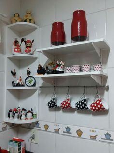 the shelves are filled with dishes and cups