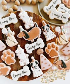 decorated cookies on a wooden plate with dog and cat sayings in english or french