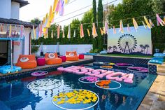 an image of a pool decorated with balloons and streamers in the shape of letters