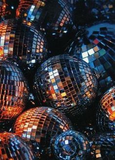 many shiny disco balls are stacked together