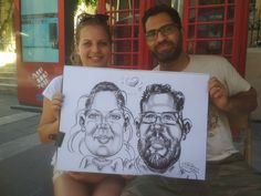 a man and woman holding up a caricature