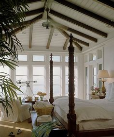 a bed room with a four post bed and a ceiling fan