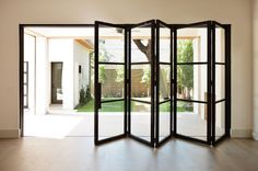 an open room divider sitting on top of a hard wood floor next to a doorway