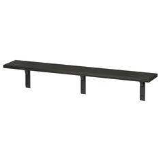 a black shelf sitting on top of a white wall