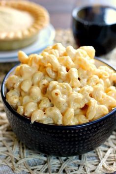 a bowl filled with macaroni and cheese on top of a table