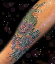 a woman's arm with flowers on it