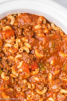 a white bowl filled with pasta and sauce