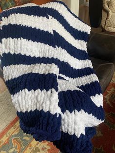 a blue and white blanket sitting on top of a chair