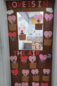 a door decorated with paper hearts and the words love is in