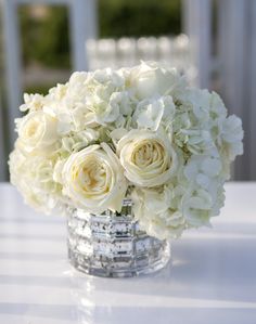 a vase filled with white flowers sitting on top of a table next to an instagram page