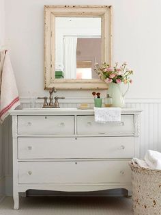 a white bathroom with two sinks and three mirrors on the wall next to each other