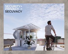 a man riding a bike past a small white building with a roof on it's side