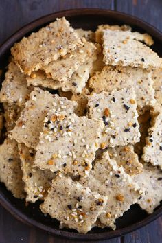 a bowl filled with crackers on top of a wooden table