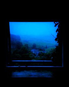 the view from an open window in a dark room