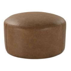 a brown leather ottoman sitting on top of a white floor