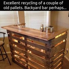 a bar made out of pallets with lights on it and the words, bar de pal