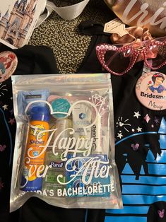 an assortment of personal care items in a clear bag next to some disney themed merchandise