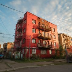 an orange building with balconies on the second floor