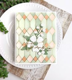 a white plate topped with a card and flowers