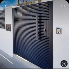 a black and white building with shutters on it