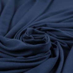 a close up view of the fabric on a dark blue shirting material that is very soft