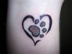 a heart shaped tattoo with paw prints on it