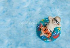 a baby is laying on an inflatable raft wearing sunglasses and a life jacket