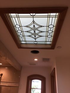 a bathroom with a glass skylight above the bathtub