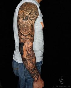 a man with a full sleeve tattoo on his arm and shoulder is standing in front of a black background