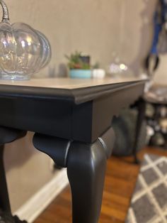 a black table with a glass ball on top