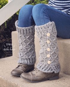 a woman's legs wearing boots with buttons and knitted leg warmers sitting on concrete steps