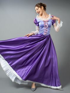 a woman in a purple dress is dancing