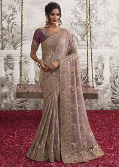 This free flowing saree gives you a charming and elegant look on drape. Simple, classy and comfortable for any wedding and festive. --------------------------------- S A R E E ● D E T A I L S --------------------------------- ● Fall and Edging : Done ● Tassel : See in Option ● Petticoat : On request Extra Charges ● Drapping Saree (Ready to wear) : On Request Extra Charges ● Blouse : Matching Unstitched Piece (See in option) ● Occasion : Wedding, Party, Festive, Function ● Type: Bollywood ● Includes : 1 Saree, 1 Blouse Piece ● Saree length : 5.5 meter ● Blouse piece : 0.8 meter ● Wash Instruction:- Dry Clean Only Premium quality Product with Fine Finishing 🎁      Gift for Women This lovely Organza Silk Saree makes for a fantastic gift for your special and loved ones on their special day or