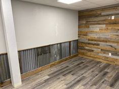 an empty room with wood paneling on the walls