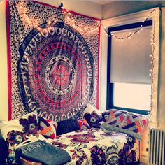 a room with a bed and a tapestry on the wall